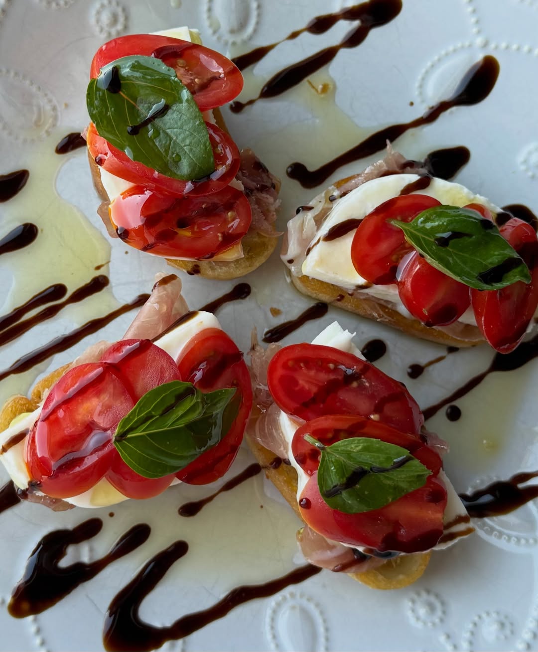 Caprese crostini with tomato, mozzarella, basil and balsamic drizzle